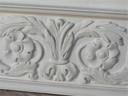 White coating covers the woodwork and sculptures